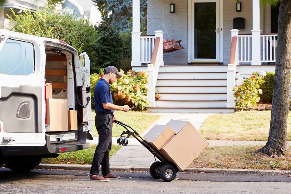 courier-knocking-on-door-of-house-to-deliver-packa-2024-10-20-23-05-54-utc courier-knocking-on-door-of-house-to-deliver-packa-2024-10-20-23-05-54-utc