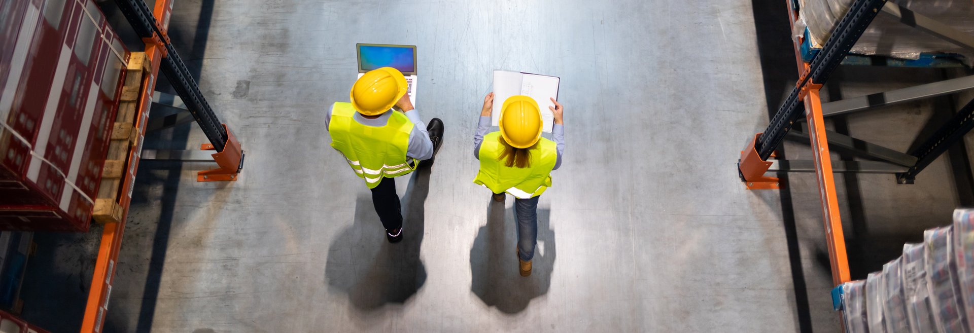 warehouse-workers-consult-delivery-plans-using-lap-2023-11-27-05-33-13-utc